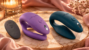 Abstract comparison of two couples vibrator shapes on champagne satin