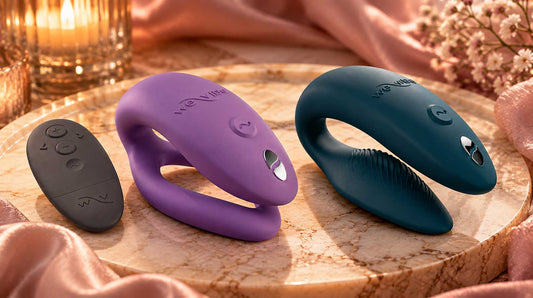 Abstract comparison of two couples vibrator shapes on champagne satin