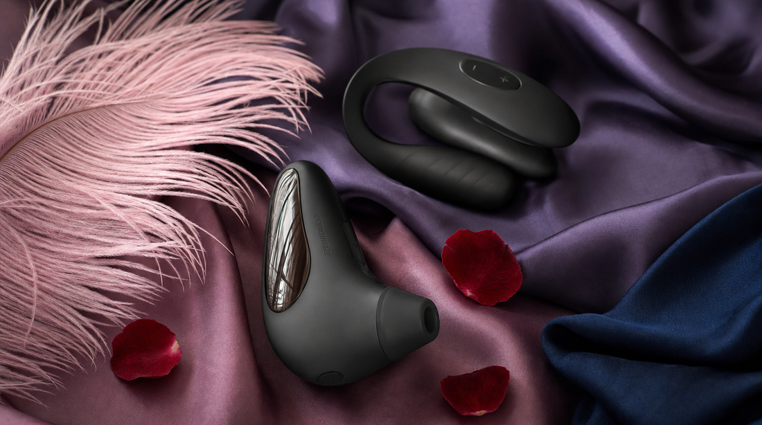Editorial flat-lay featuring luxury pleasure devices — We-Vibe Chorus Pro couples vibrator and Womanizer Next, purple silk, pink feather, rose petals