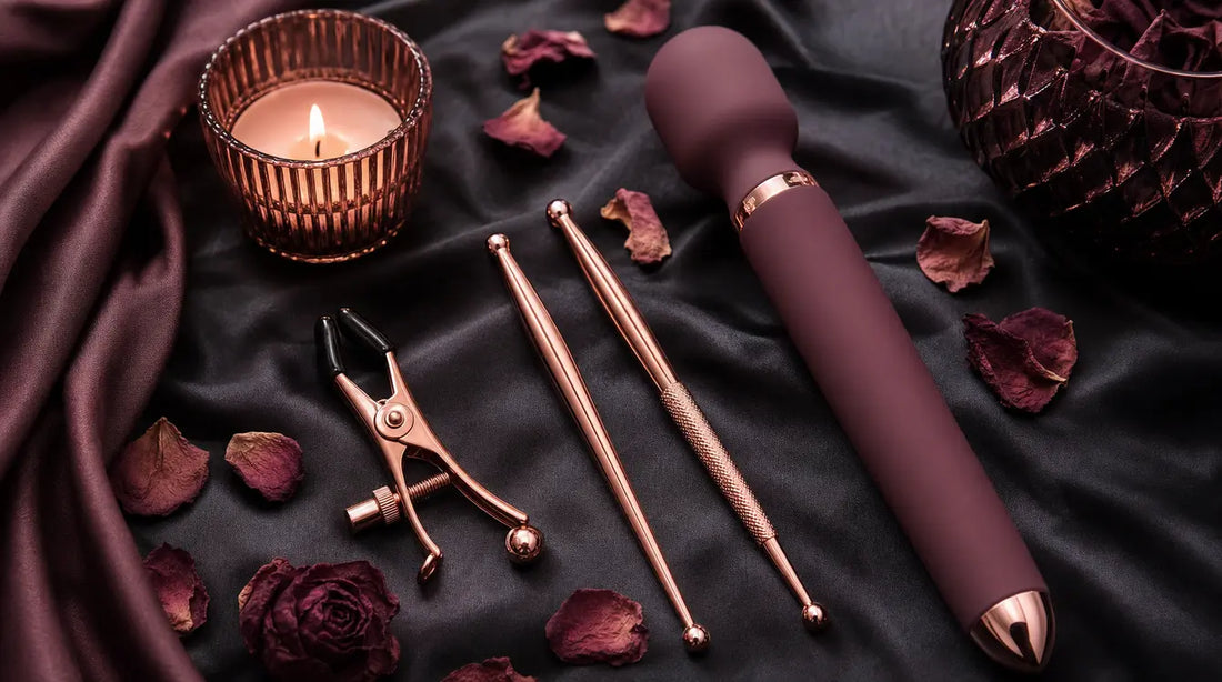 Nipple Play 101 — sensory accessories flat-lay on dark silk with rose petals