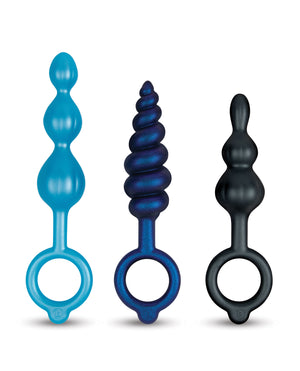 Three colorful silicone ring anal toys on a white background