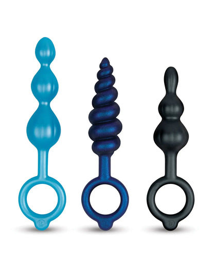 Three colorful silicone ring anal toys on a white background