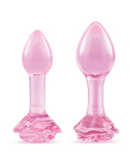 Two pink glass butt plugs on a white background