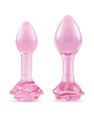 Two pink glass butt plugs on a white background