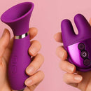 Two purple silicone products held by hands against a pink floral background