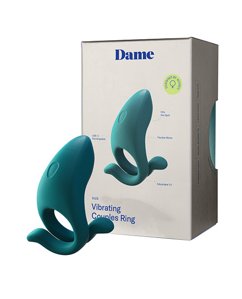 Dame Hug Vibrating Couples Ring in Fir green shown beside its retail packaging box