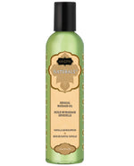 A Kamasutra Naturals Massage oil bottle  in vanilla sandalwood scent with green label on a white background