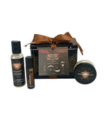 Collection of 'Sex Magnet' products including a tin, bottles, and a jar of  Leather Pheromone Massage Oil, a Leather Pheromone Roll-On Fragrance Oil, and a Leather Pheromone Massage Candle with the box it comes in on a white background