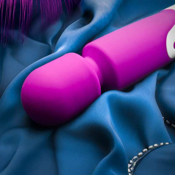 Purple object on blue fabric with feather