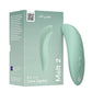 Sage green WeVibe Melt 2 We-Vibe Melt 2 Clitoral & G-spot Suction Vibrator with packaging on a white background