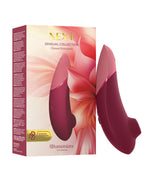 Womanizer clitoral stimulator with packaging on a white background